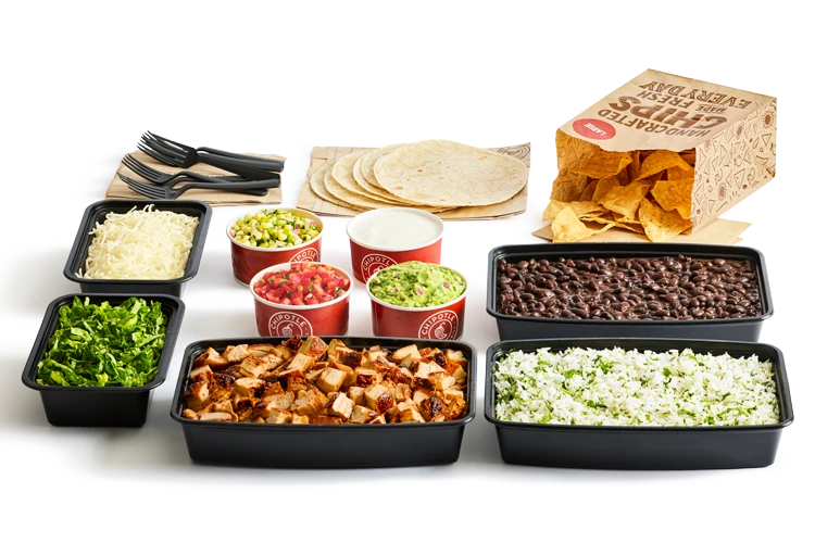 Chipotle family meal spread with proteins, rice, beans and toppings